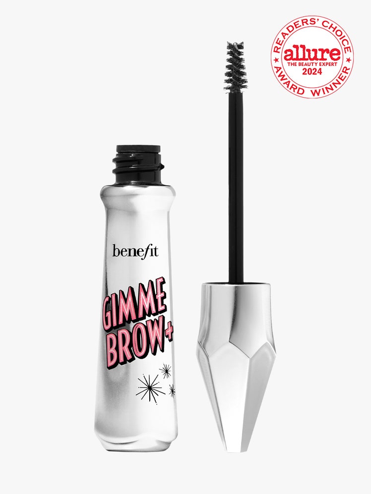 Benefit Cosmetics Gimme Brow Volumizing Eyebrow Gel silver vial of brow gel with cap and wand to the side on light gray...