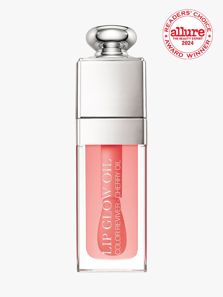 Copy of Dior Addict Lip Glow Oil vial of peach lip oil with silver bauble cap on light gray background with red and...