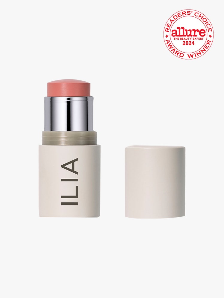 Ilia Multi-Stick Cream Blush + Highlighter + Lip Tint beige twist up stick of pink cream blush with cap to the side on light gray background with white and red Allure Readers' Choice Award in the top right corner