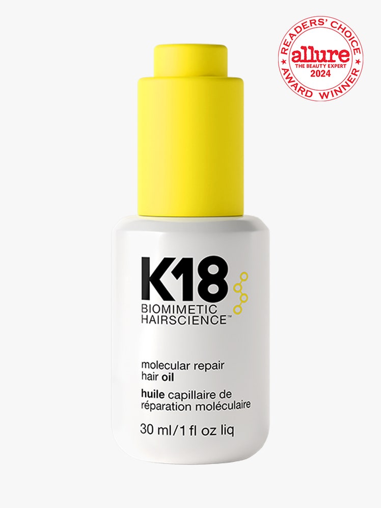 K18 Hair Oil mini white bottle with modern yellow dropper cap on light gray background with white and red Allure Readers...