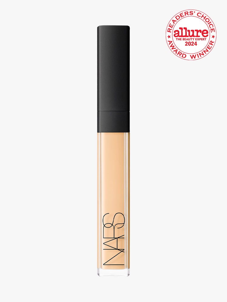 Nars Radiant Creamy Concealer vial of concealer with black cap on light gray background with white and red Allure...