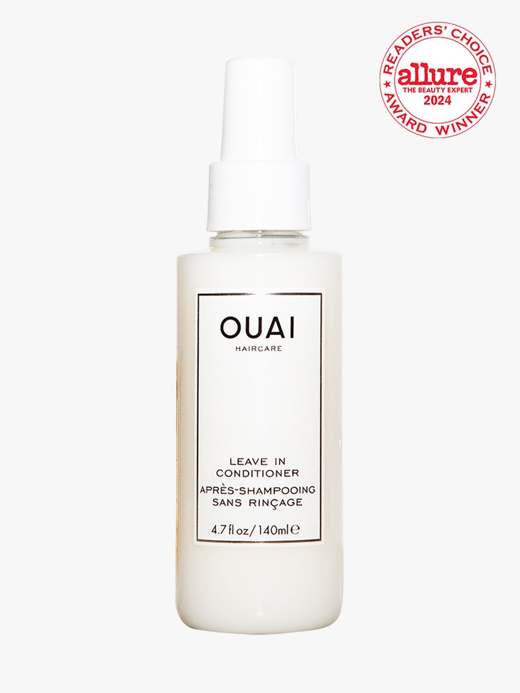 Ouai Leave-In Conditioner white spray bottle on light gray background with white and red Allure Readers' Choice Award seal in the top right corner