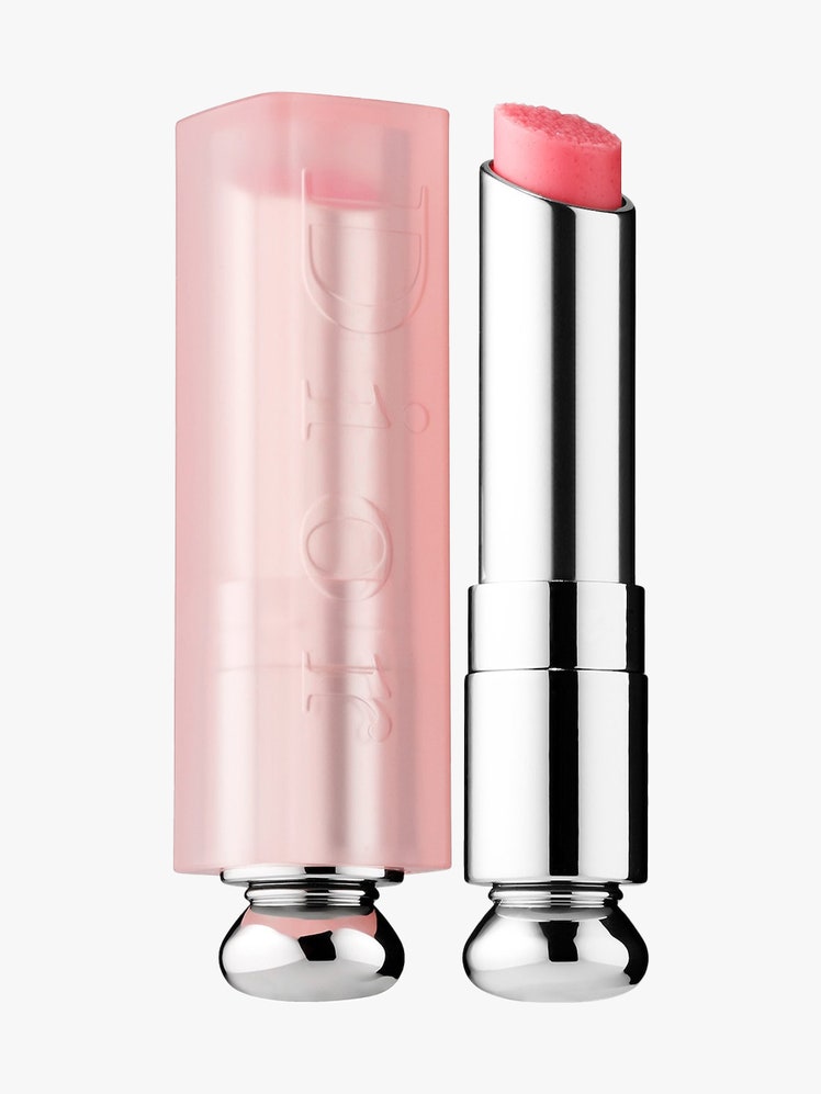 Dior Lip Sugar Scrub Sweet Exfoliating Lip Balm silver twist up tube of pink lip scrub with pink cap to the side on...