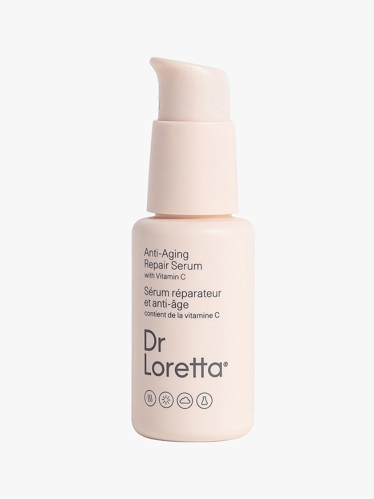 Dr. Loretta Repair Serum light pink pump bottle on light gray background