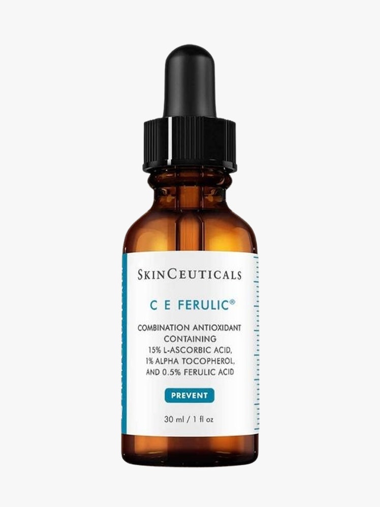 C E Ferulic brown glass bottle with white label and black top on light grey background