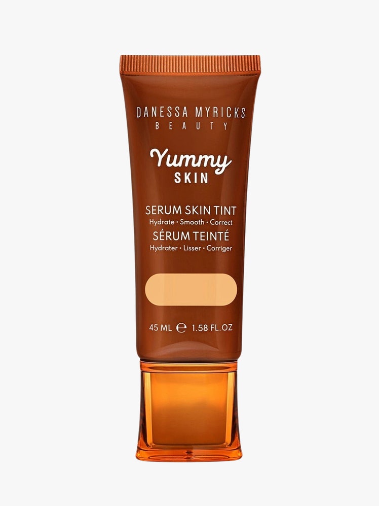 Yummy Skin Serum Skin Tint brown tube on light grey background