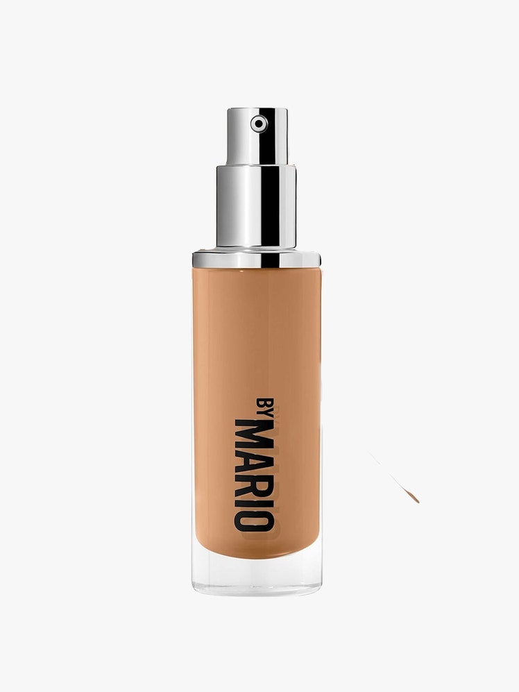 SurrealSkin Foundation brown bottle with silver cap on light grey background