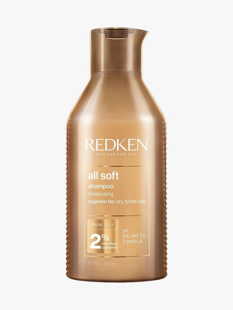 All Soft Shampoo gold bottle on light grey background