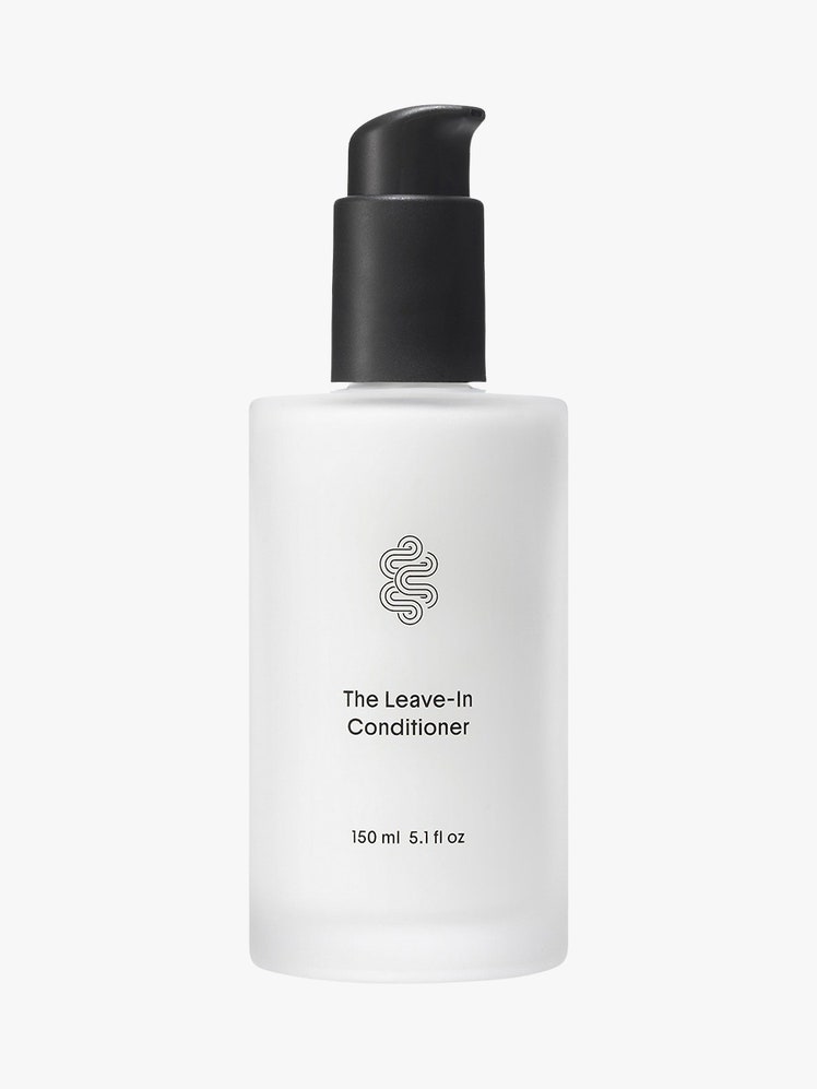 The LeaveIn Conditioner white container with black top on light grey background