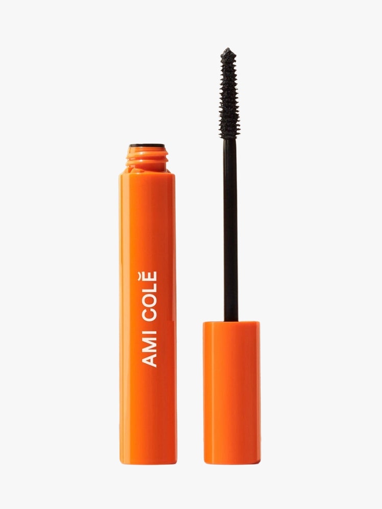 Lash Ampliying Mascara orange tube with black mascara application on light grey background