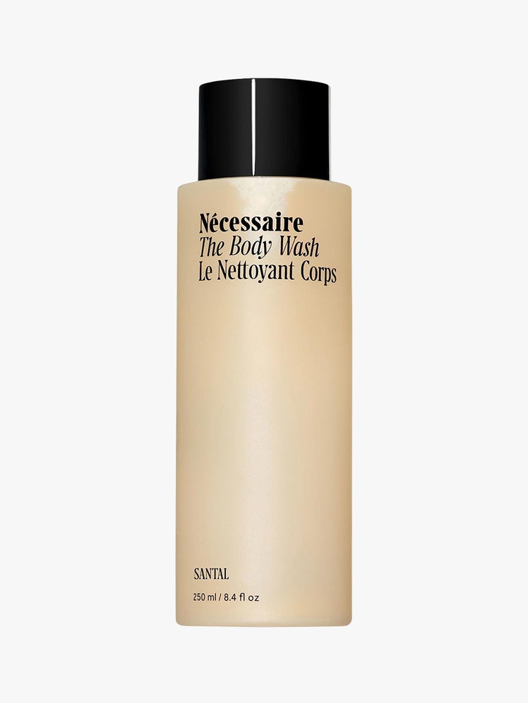 The Body Wash tan bottle with black top on light grey background