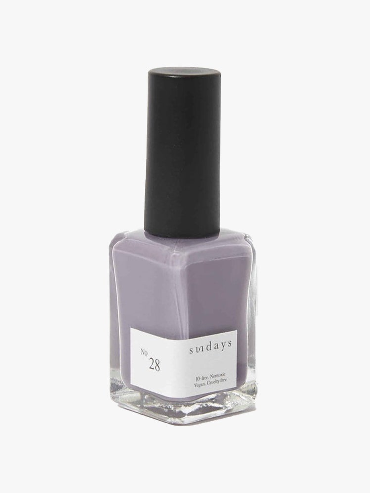 Nail Polish in No. 28 bottle of lavender nail polish with black cap on light gray background