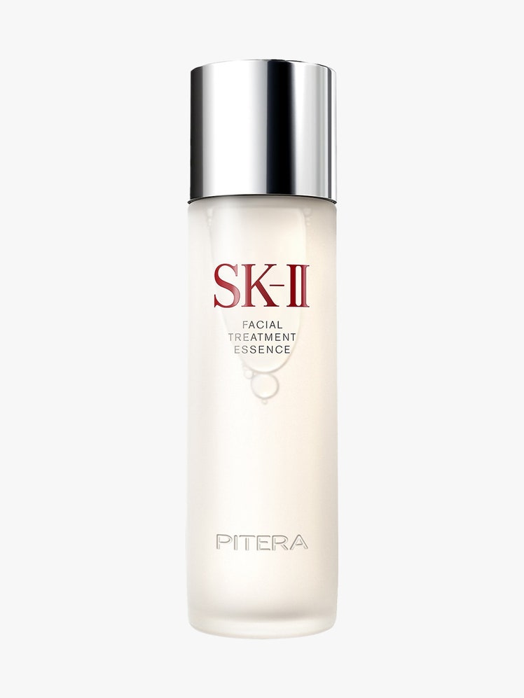 Pitera Facial Treatment Essence cloudy beige bottle with silver cap on light gray background