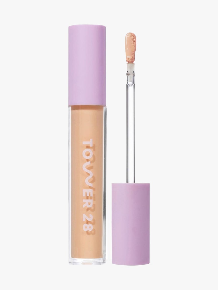 Tower 28 Swipe Serum Concealer vial of concealer with lavender cap and wand to the side on light gray background