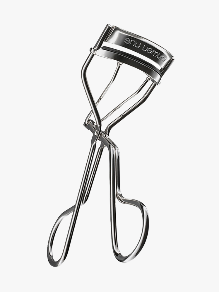 Iconic Eyelash Curler in branded silver metal on light gray background